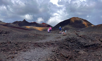 People walking to the sierra negra volcano on Isabela Island Galapagos.